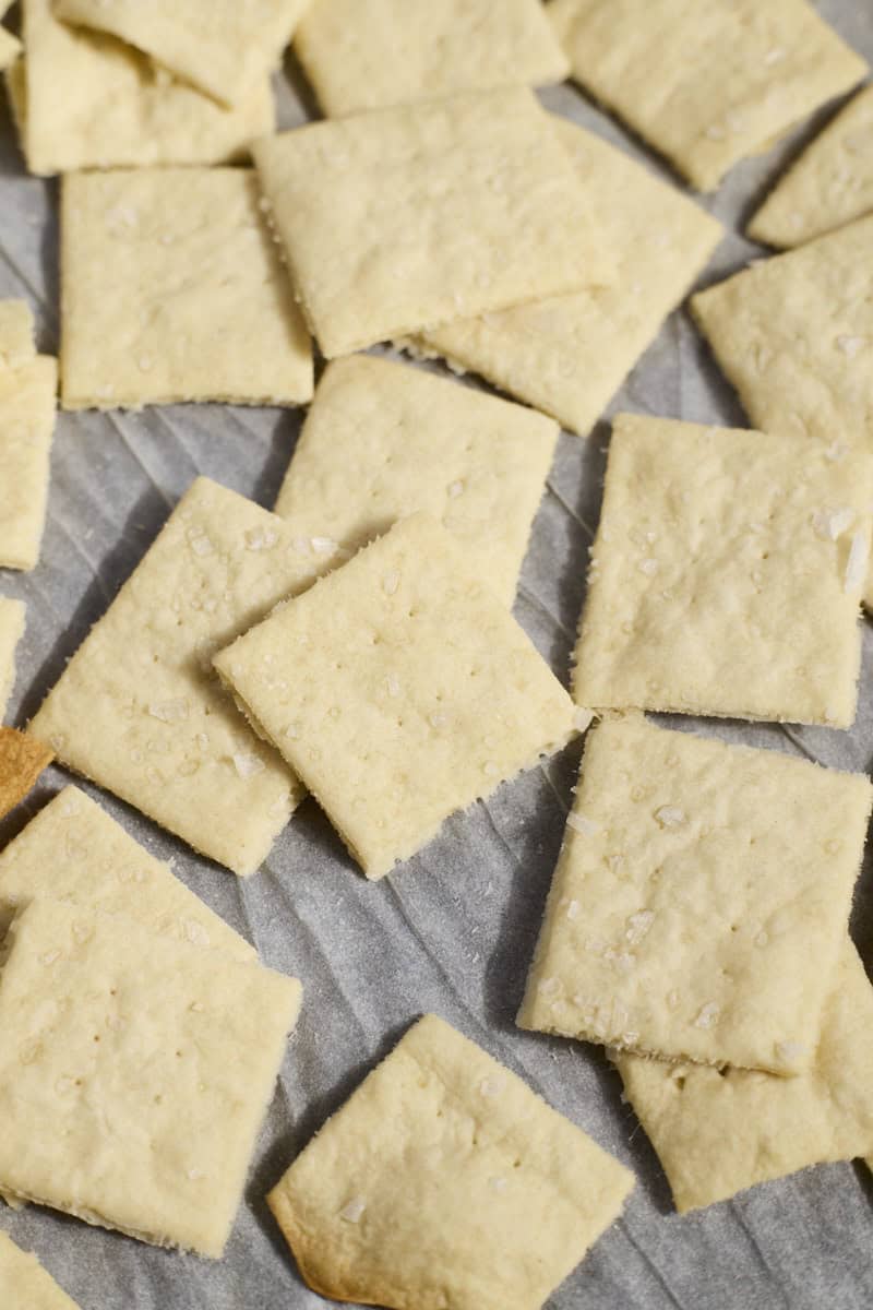 Baked crackers on white parchment paper.