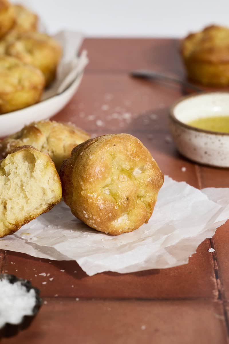 Mini Sourdough Discard Focaccia Muffins on a piece of parchment paper.
