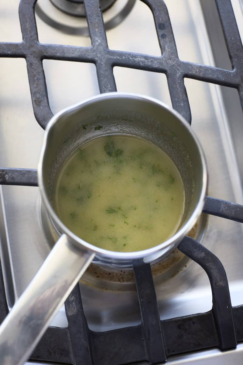 Melted butter mixture in a small pot on the stovetop.