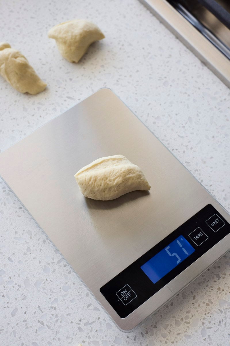 Dough being weighed on a kitchen scale.