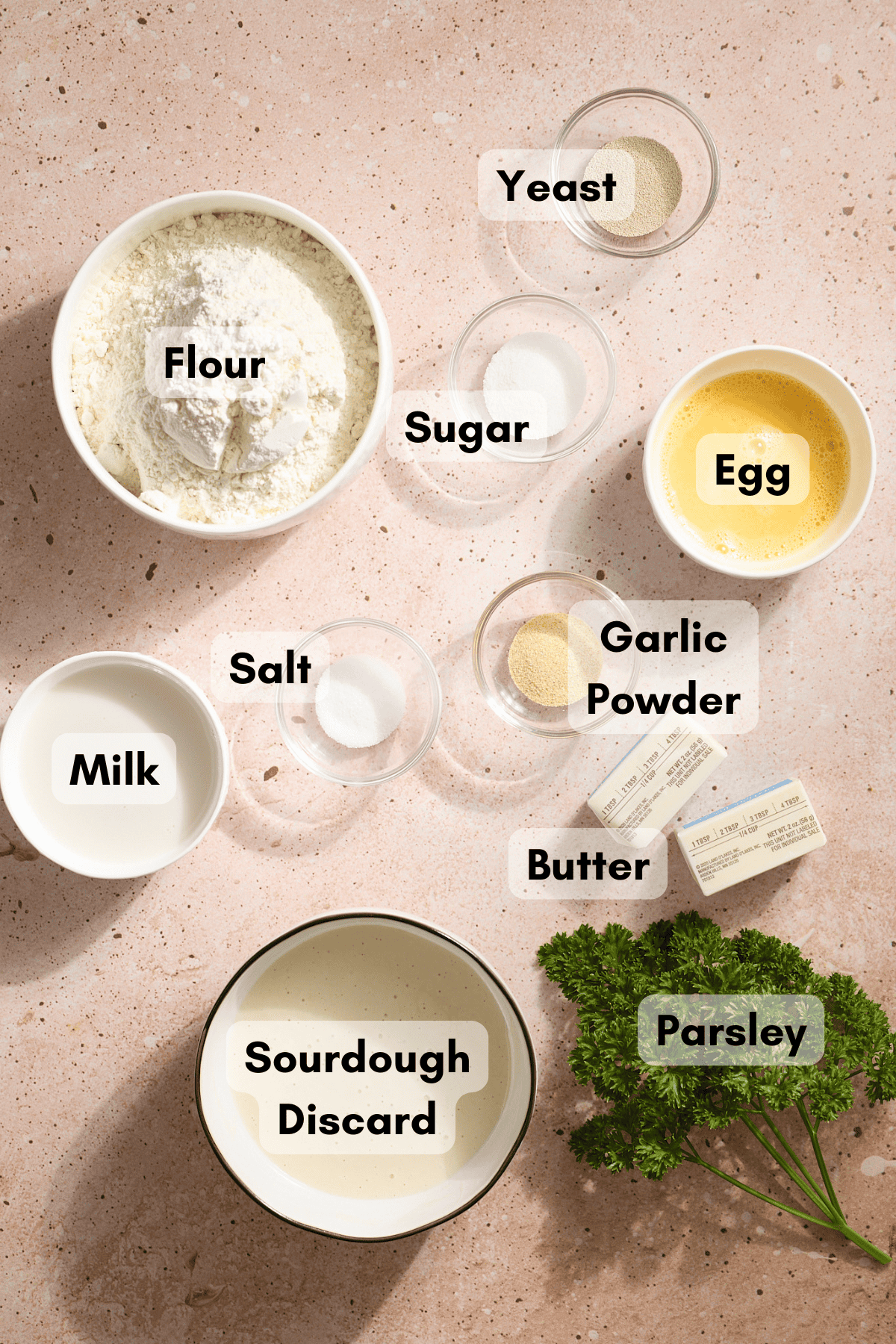 Ingredients for Sourdough Discard Garlic Knots in small bowls. 