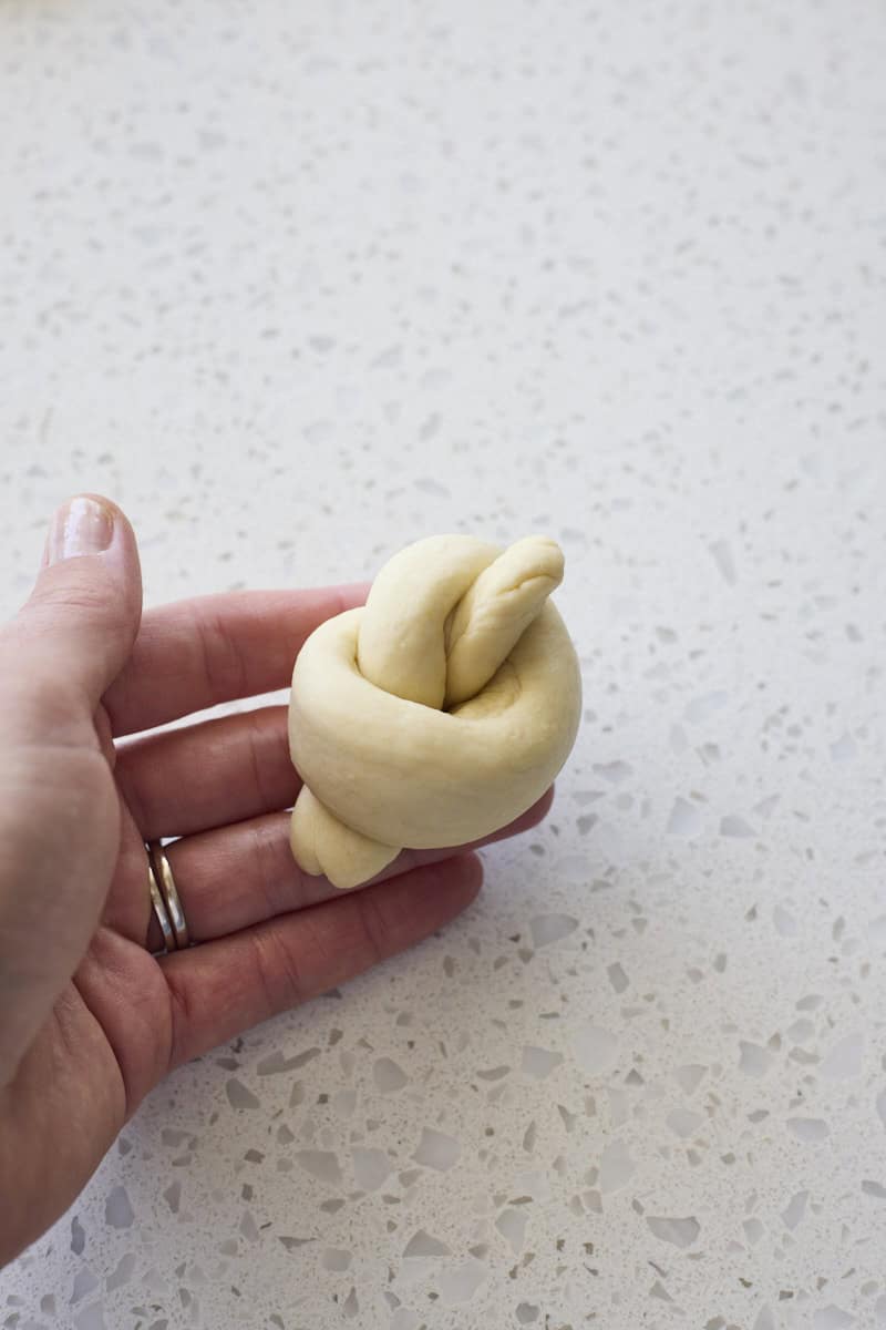A garlic knot shaped in a hand.