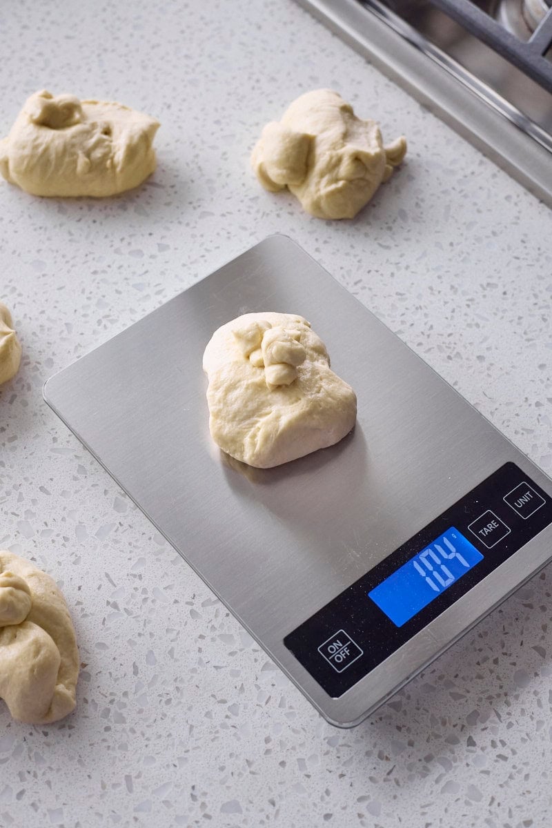 Dough being weighed on a kitchen scale.