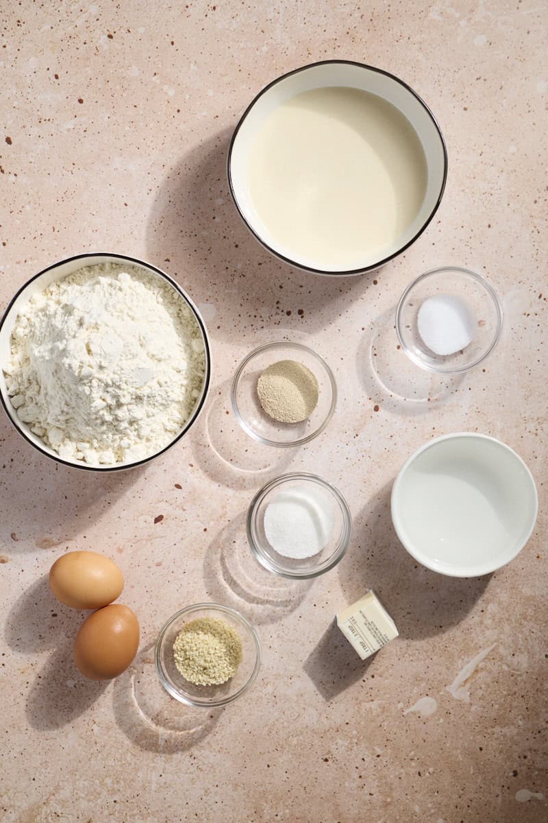 Ingredients for Sourdough Discard Hamburger Buns in small bowls.