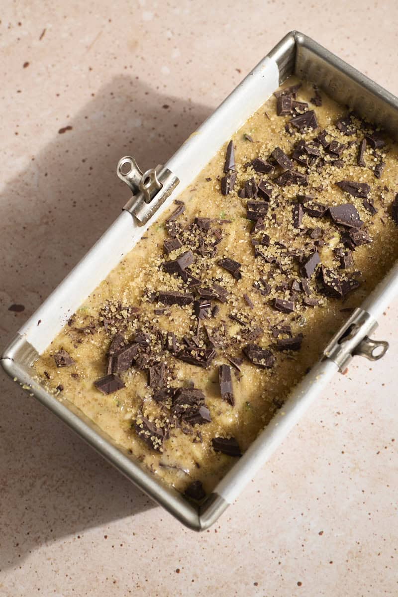 Chocolate chips sprinkled on top of the batter in the baking pan.
