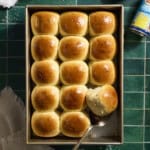An overhead view of Sourdough Discard Hawaiian Rolls in the baking pan.
