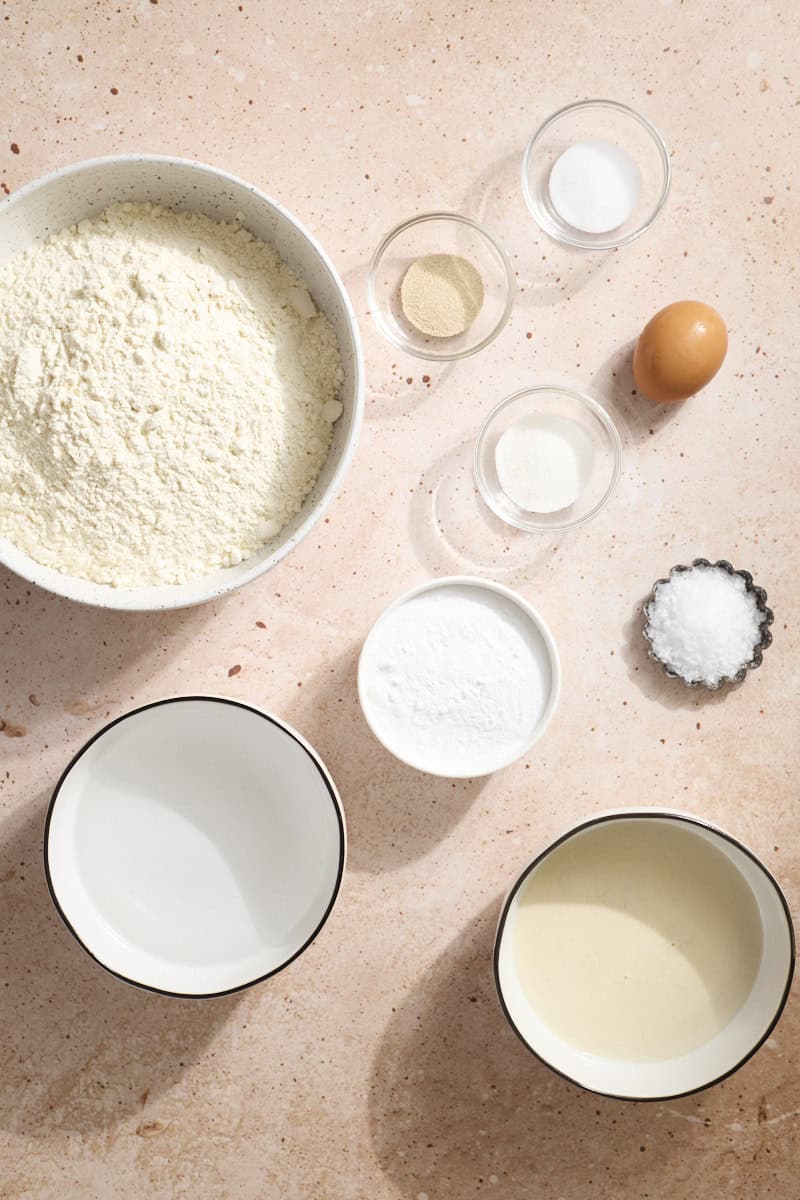 Ingredients for Sourdough Discard Pretzel Bagels in small bowls.