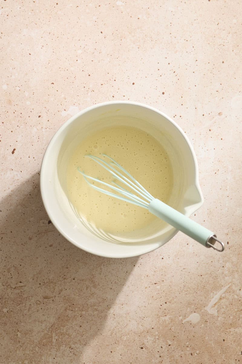 Wet ingredients mixed in a white bowl.