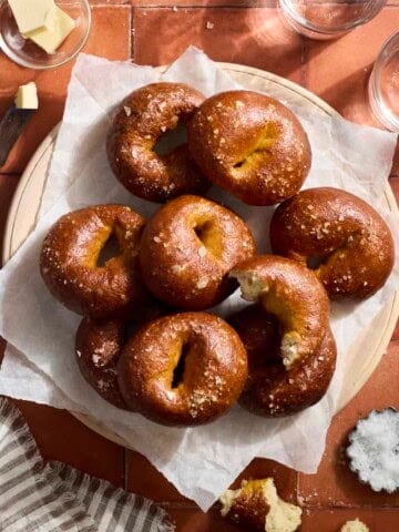 A pile of Sourdough Discard Pretzel Bagels on a platter.