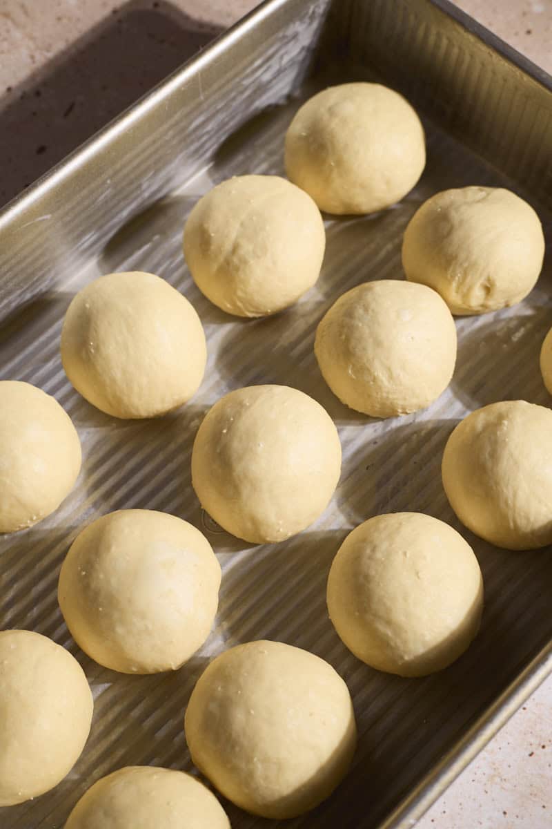 Dough shaped into balls in the baking pan.