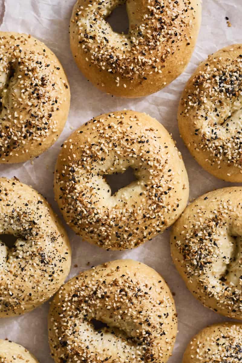 Homemade Everything Bagels on white parchment paper.