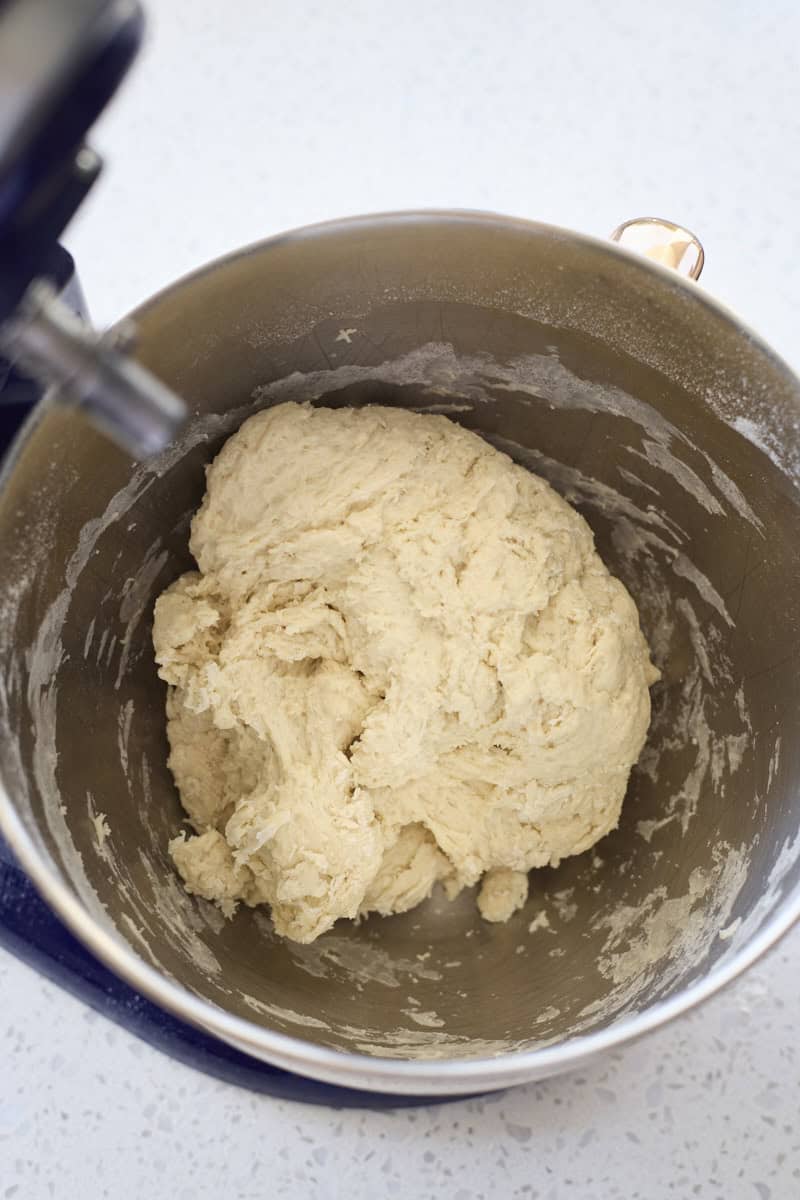 Dough mixed in the bowl of a stand mixer.