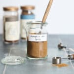 Pumpkin Pie Spice in a small jar with a spoon.