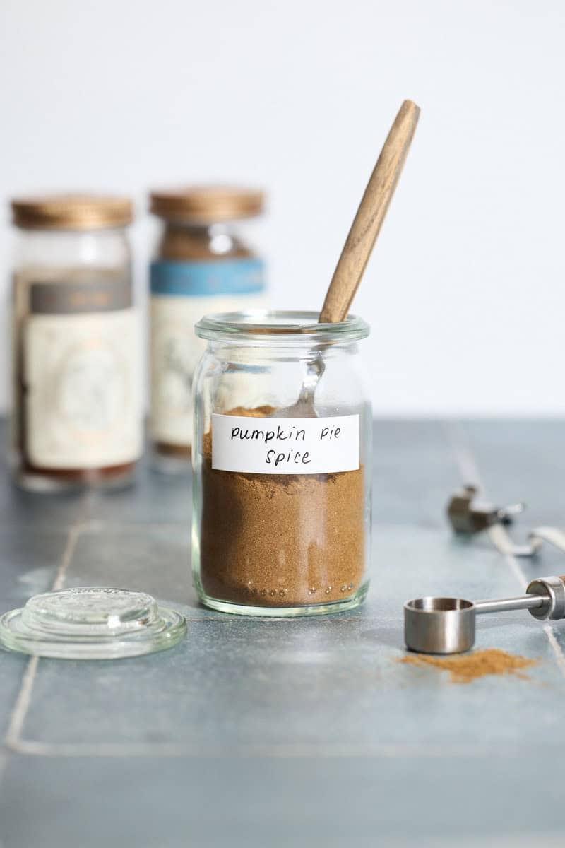 Pumpkin Pie Spice in a small jar with a spoon.