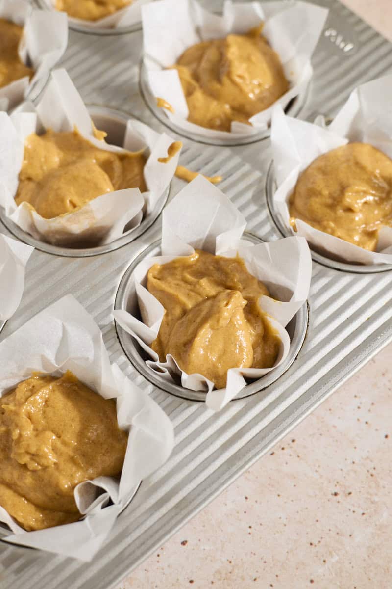 Muffin batter in the muffin pan.