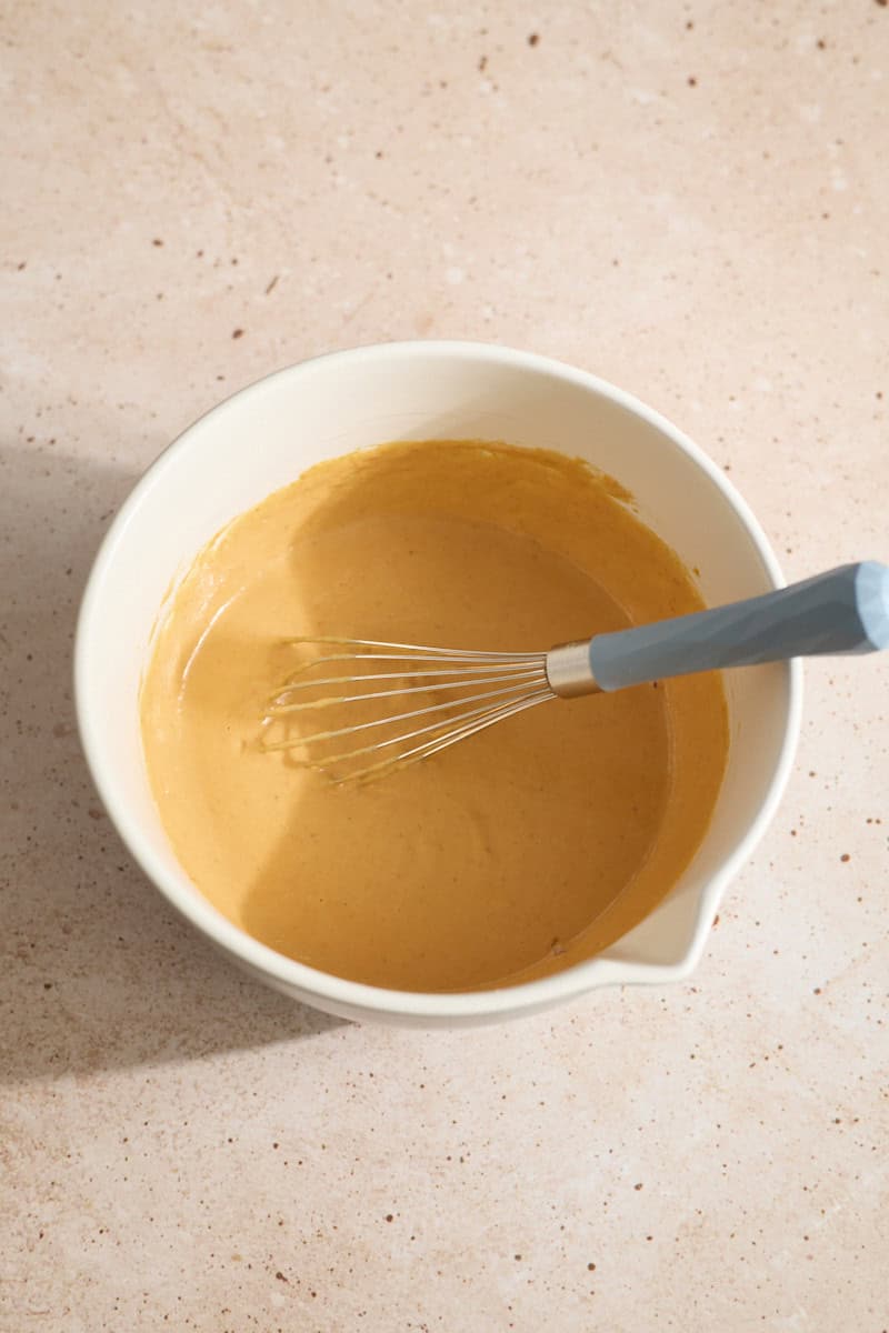 Wet ingredients mixed in a white mixing bowl.