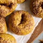 Sourdough Discard Pumpkin Bagels in a stack on a wooden tray.