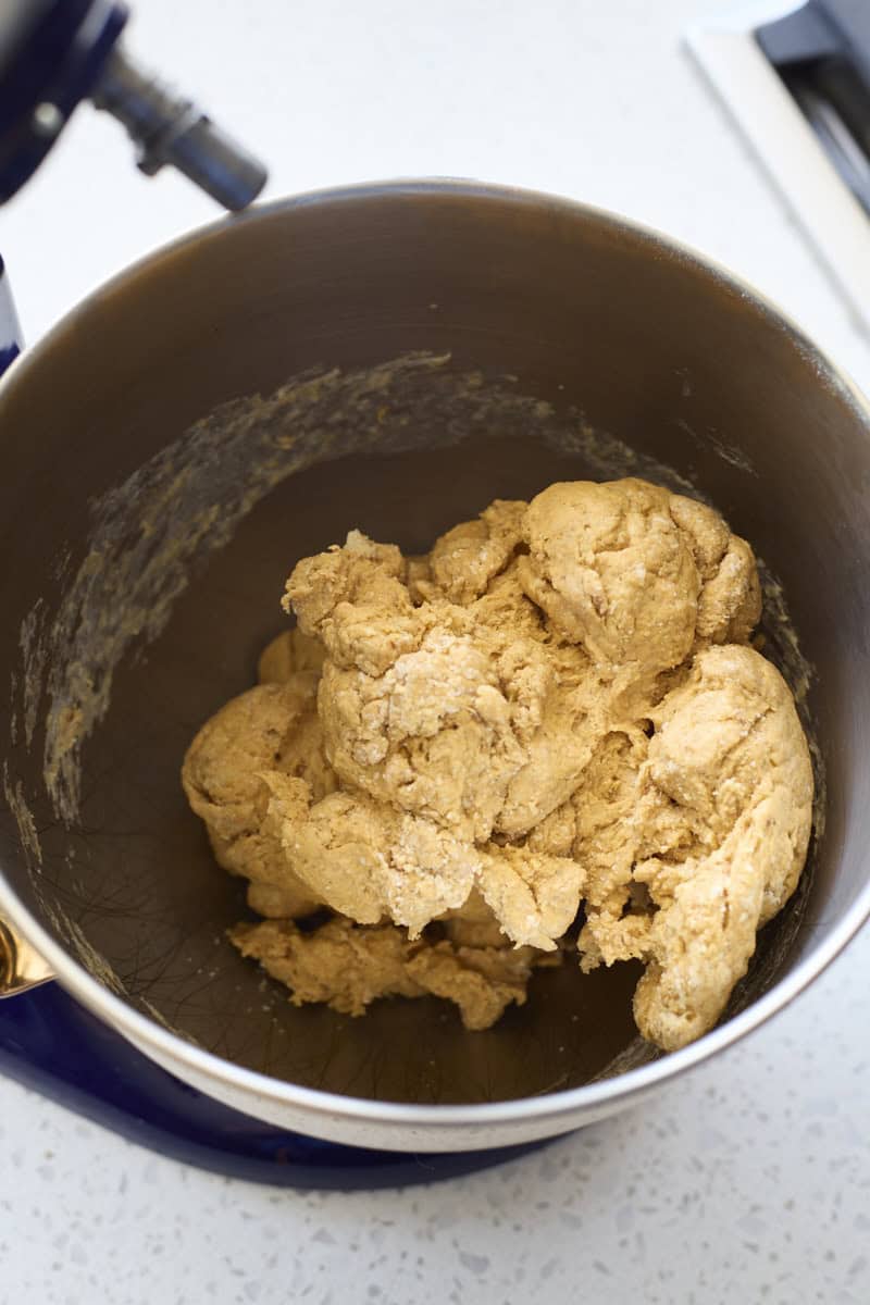 Dough in the bowl of a stand mixer.