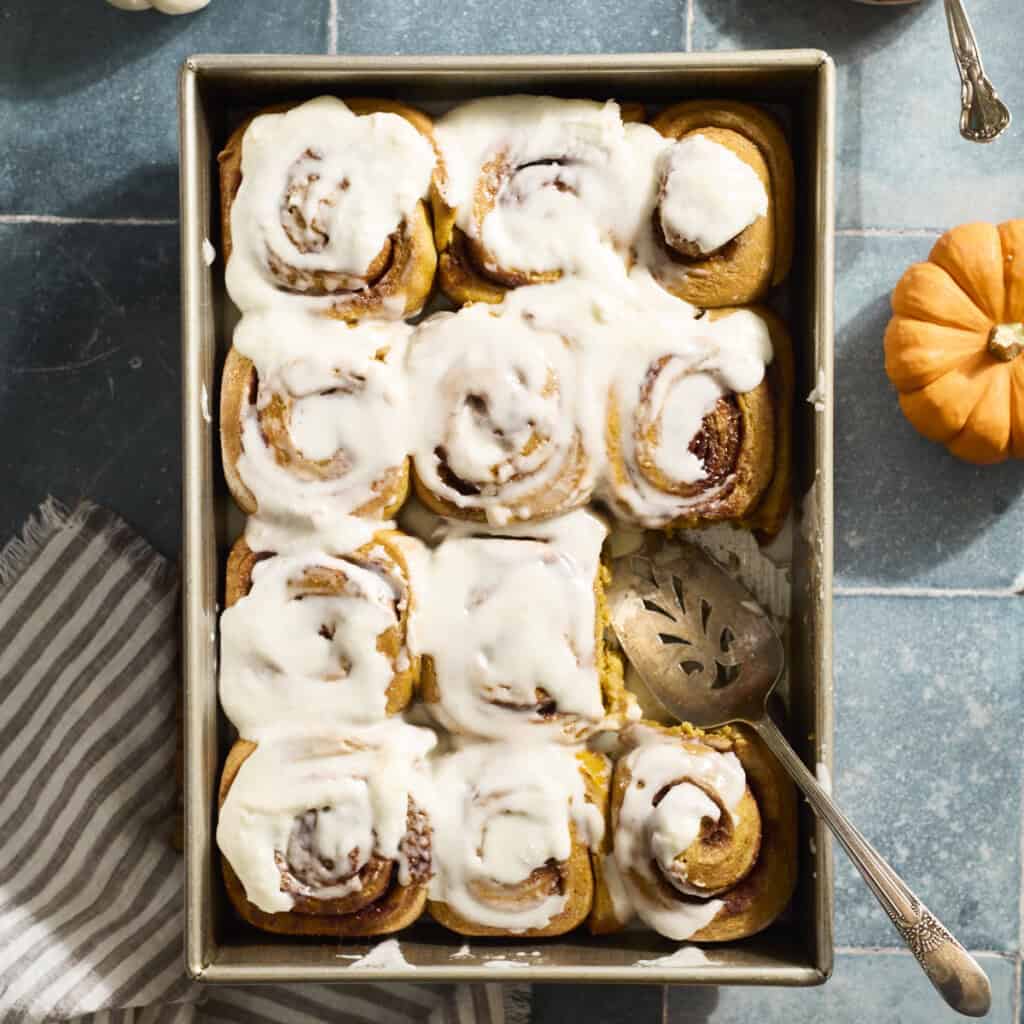 Sourdough Discard Pumpkin Cinnamon Rolls in a baking pan.