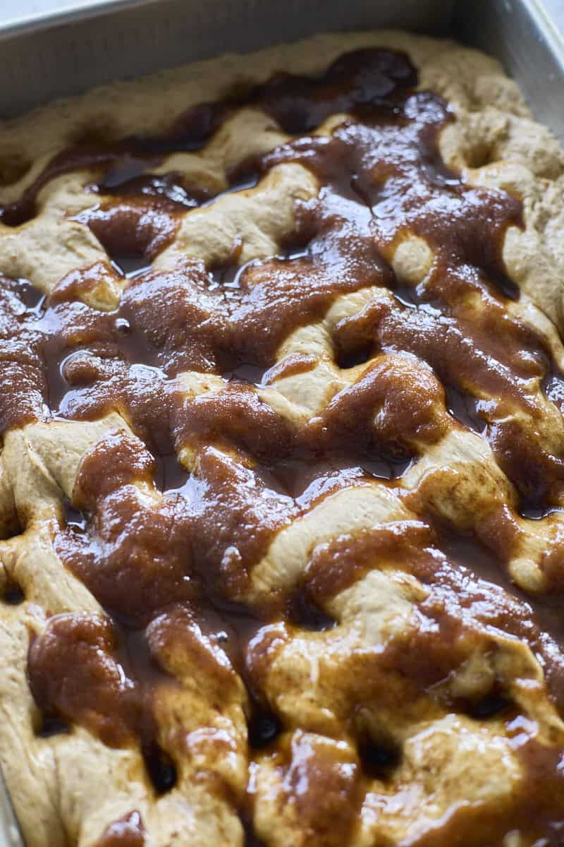 Focaccia dimpled with the topping.