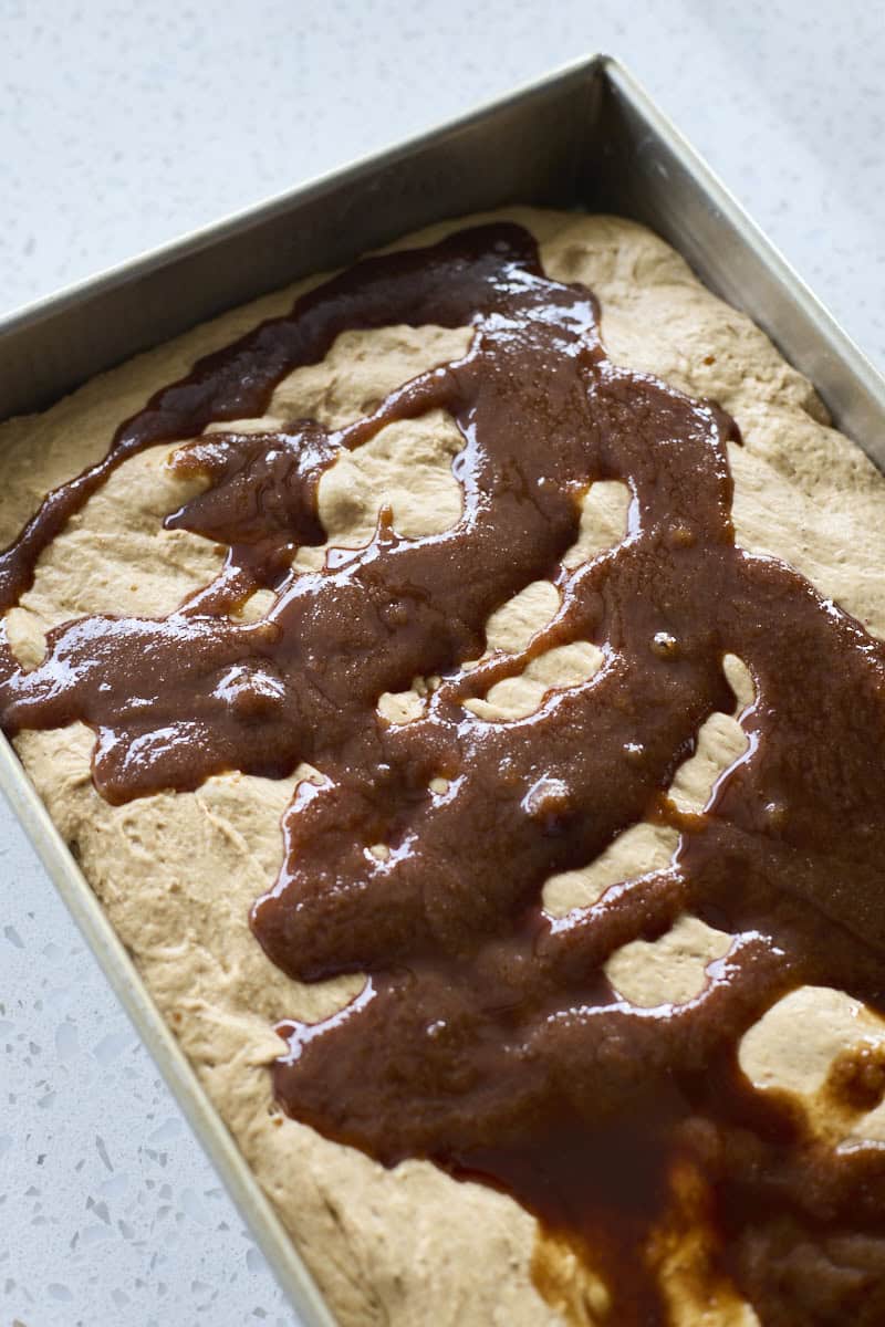 Topping drizzled on top of the focaccia dough.