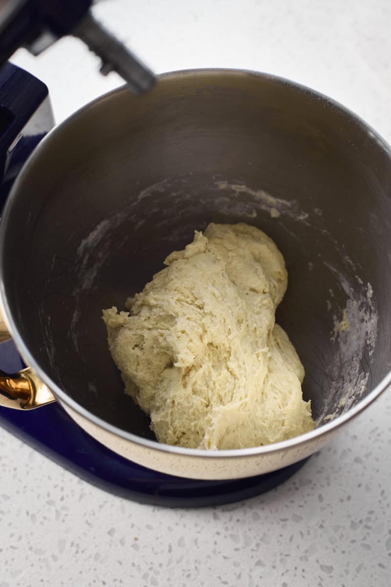 Dough mixed in the bowl of a stand mixer.