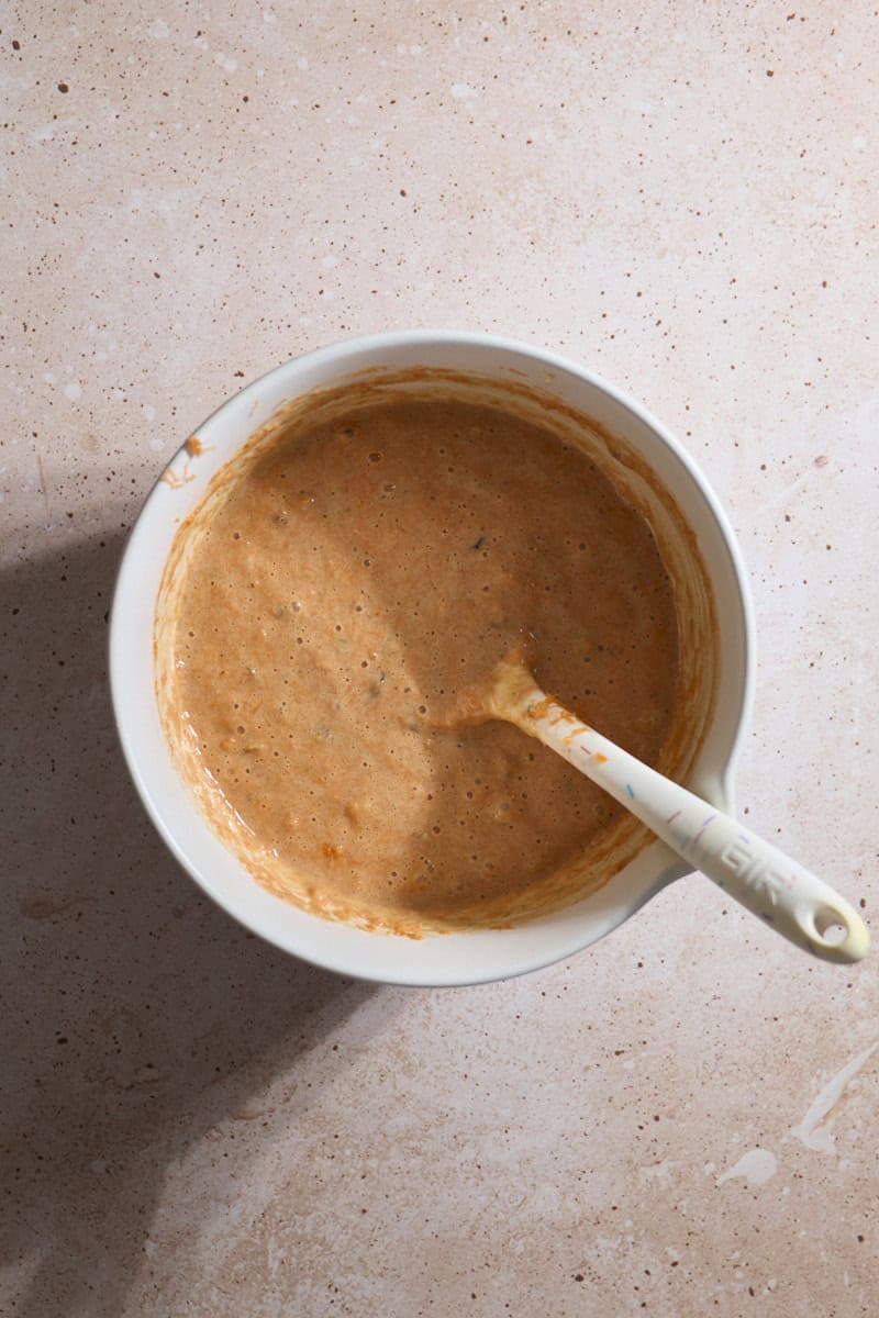 Cake batter mixed in a white bowl.