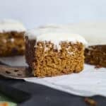 A side view of a piece of Sourdough Discard Carrot Cake.