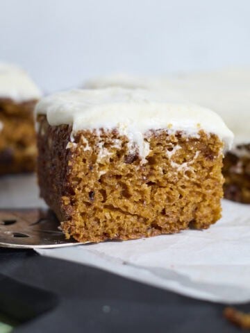A side view of a piece of Sourdough Discard Carrot Cake.