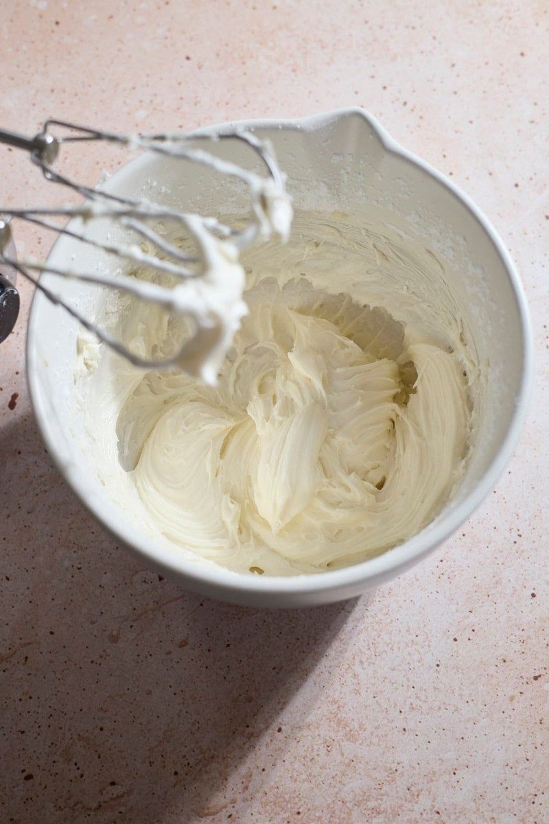 Icing whipped in a white bowl.