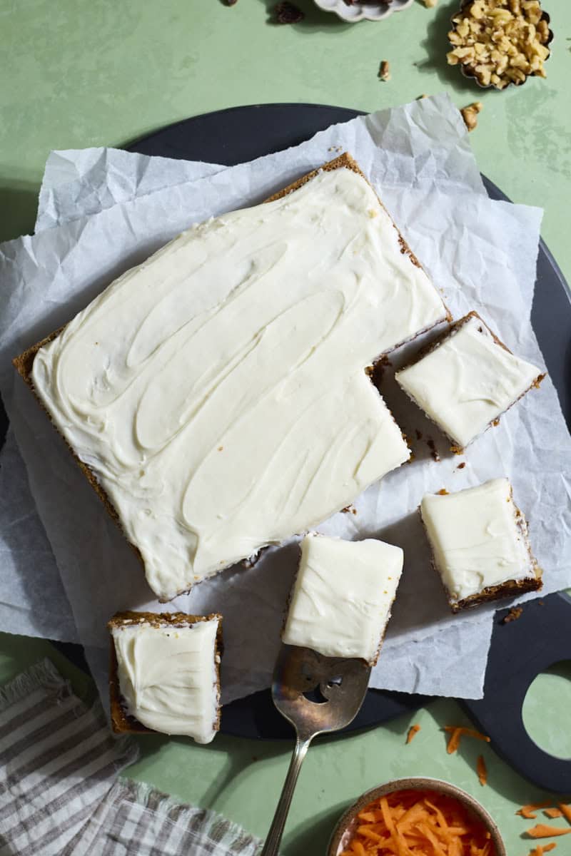 An overhead view of a Sourdough Discard Carrot Cake with several slices cut.