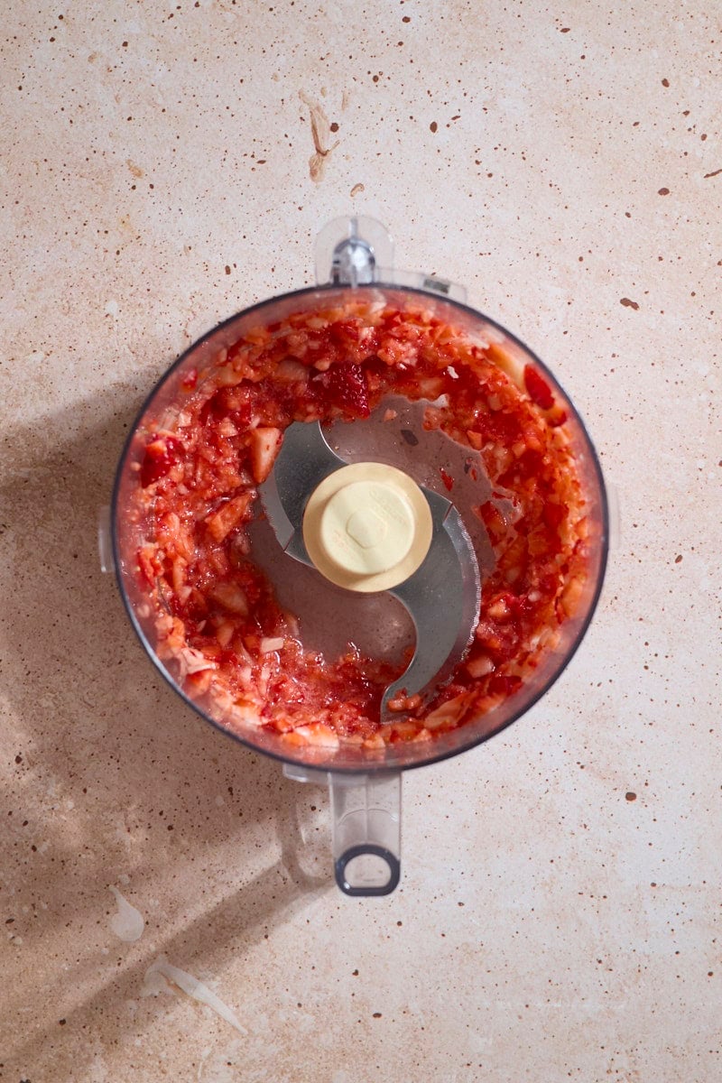 Crushed strawberries in a food processor.