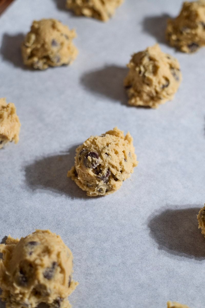 Cookie dough balls on a baking sheet.