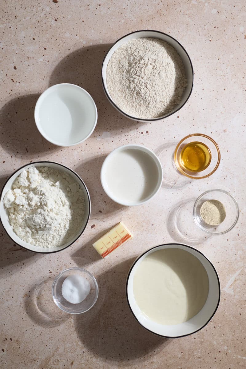 Ingredients for Sourdough Discard Whole Wheat Sandwich Bread in small bowls.