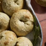 Sourdough Discard Rosemary Salt Bagels in a round metal tray.
