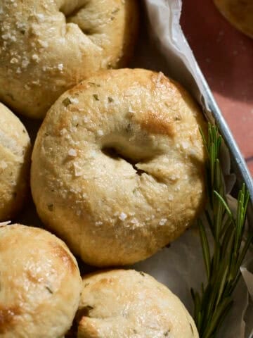 Sourdough Discard Rosemary Salt Bagels in a round metal tray.