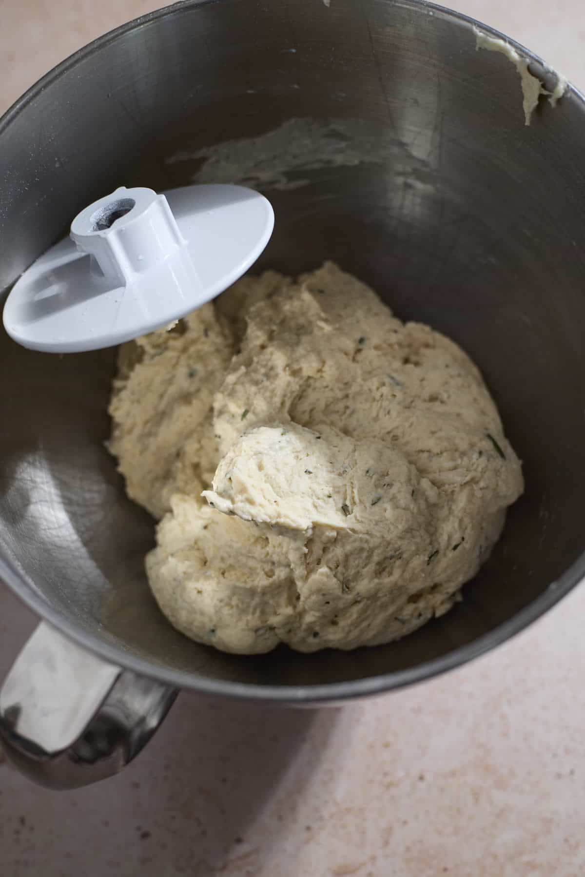 Dough in the bowl of a stand mixer.