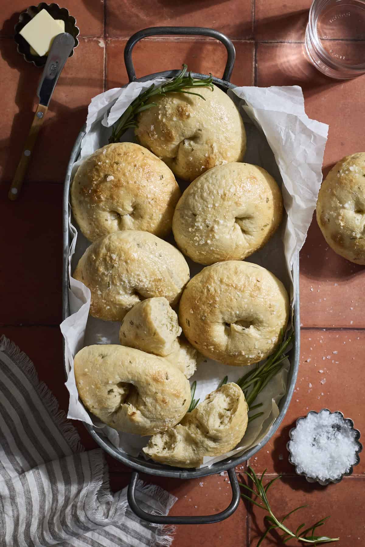 Sourdough Discard Rosemary Salt Bagels in a round metal tray.