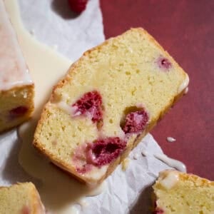 A slice of Sourdough Lemon Raspberry Loaf Cake.
