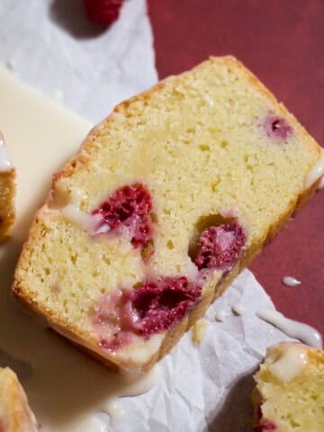 A slice of Sourdough Lemon Raspberry Loaf Cake.