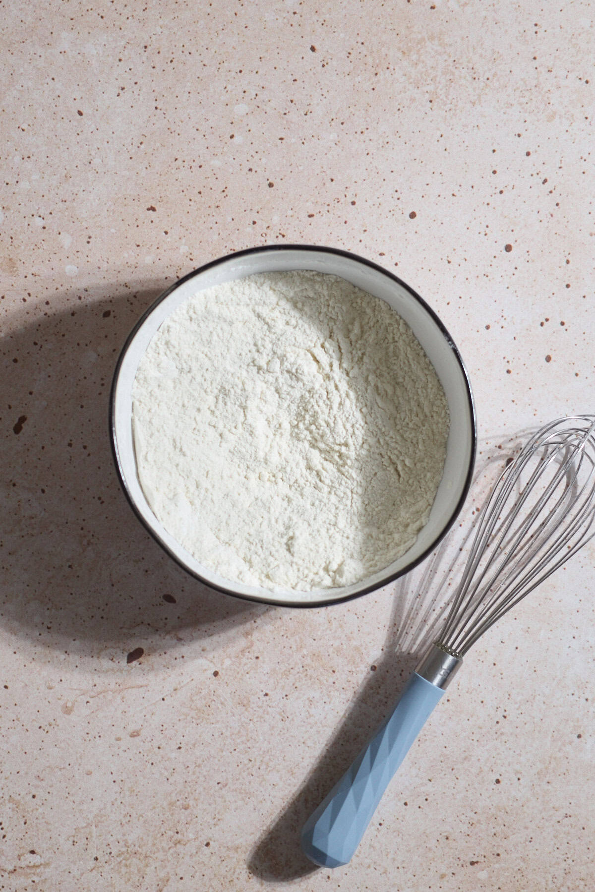 Dry ingredients mixed in a white bowl.