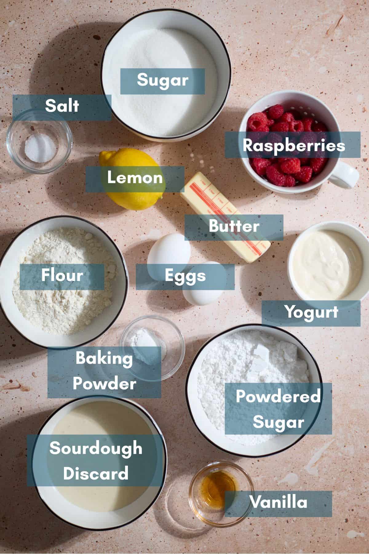 Ingredients for Sourdough Lemon Raspberry Loaf Cake in small bowls.