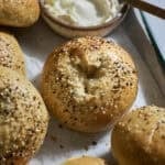 Sourdough Discard Protein Bagels on a green tray with cream cheese.