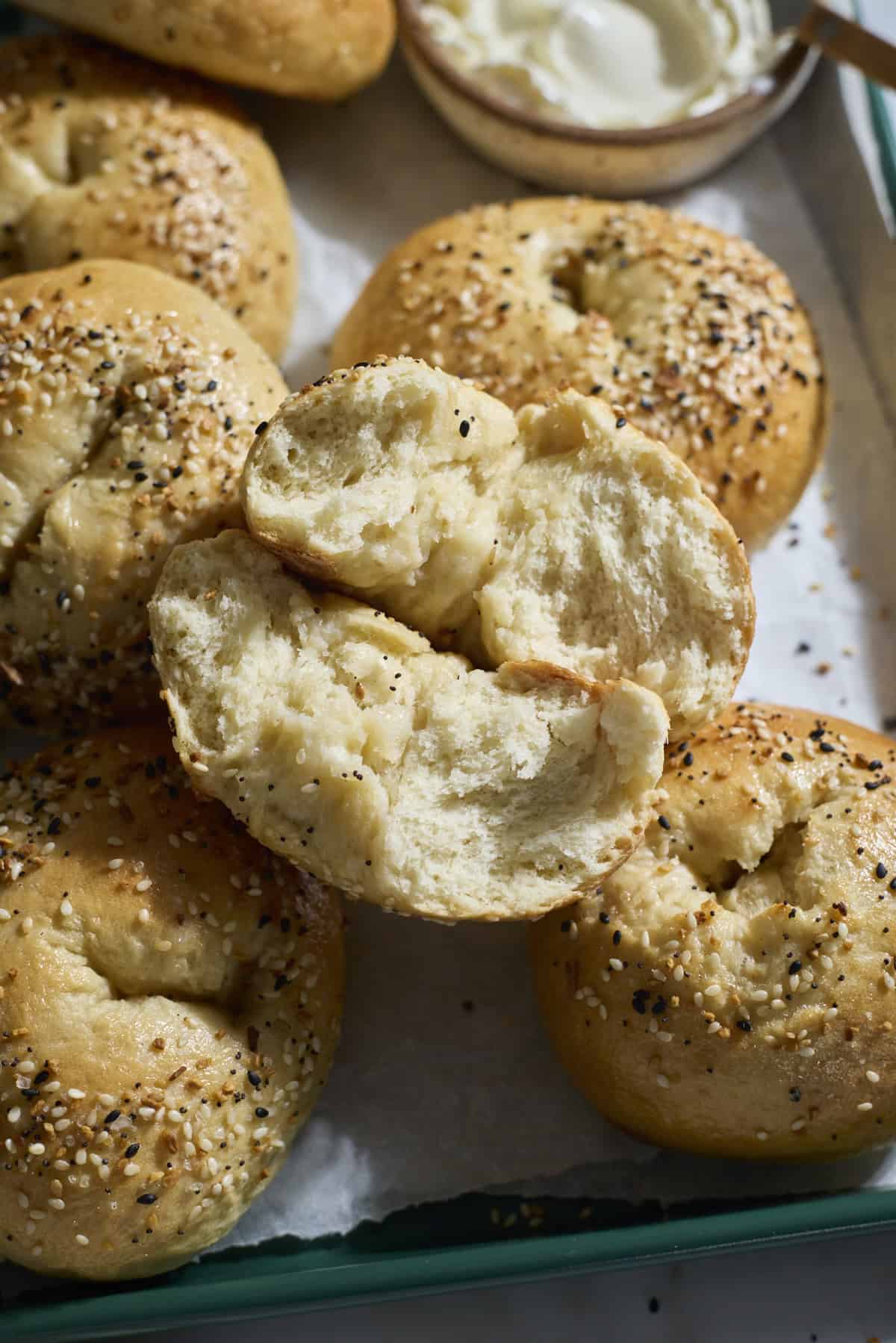 A bagel torn in half to show the fluffy interior.