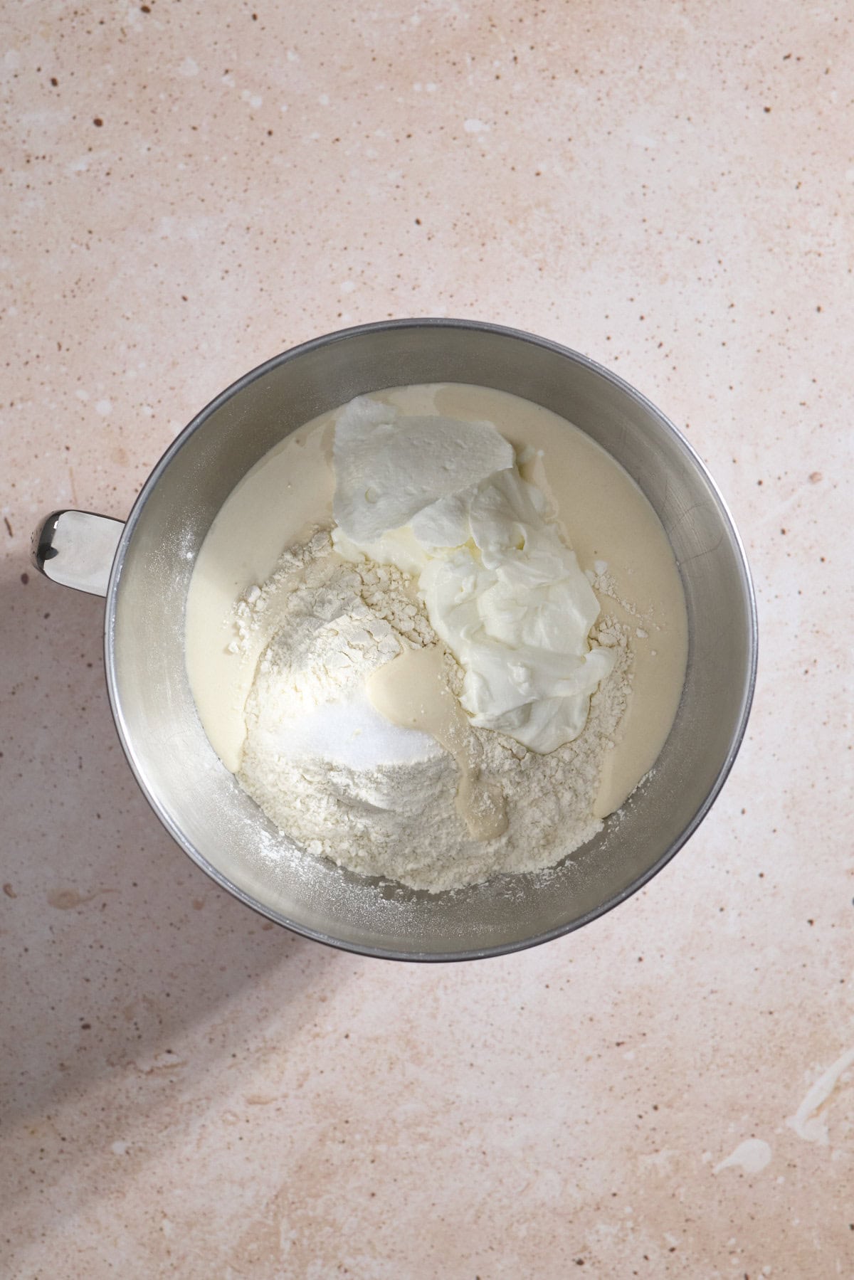 Bagel ingredients in the bowl of a stand mixer.