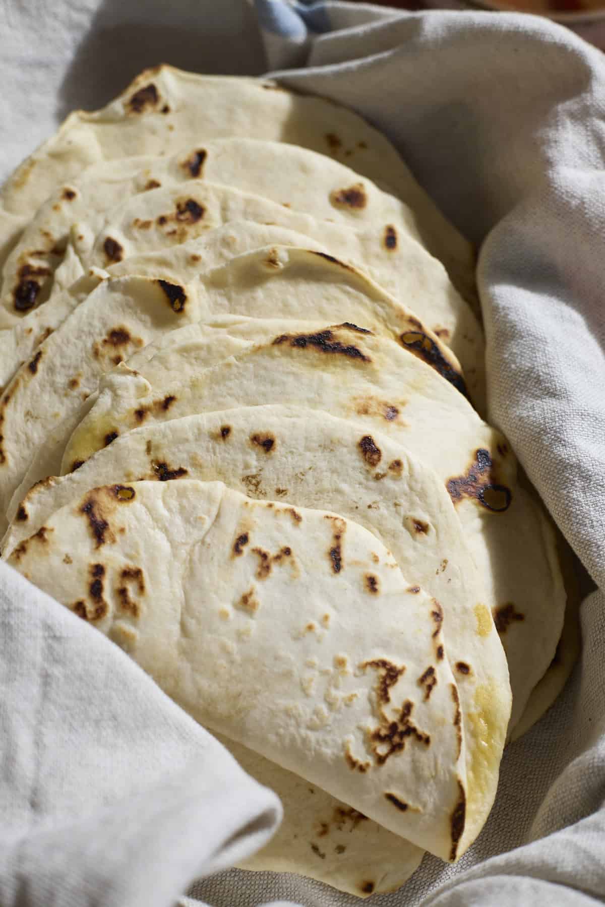 Sourdough Discard Tortillas wrapped in a kitchen towel.