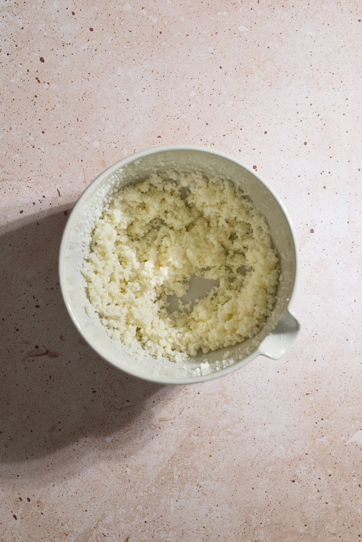 Butter and sugar creamed together in a large bowl.