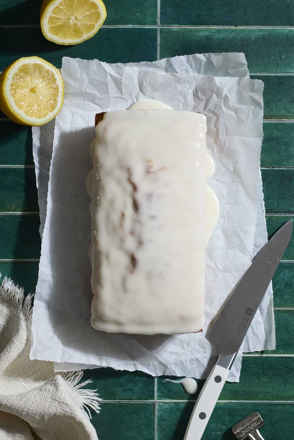 Glaze poured over the lemon loaf cake.