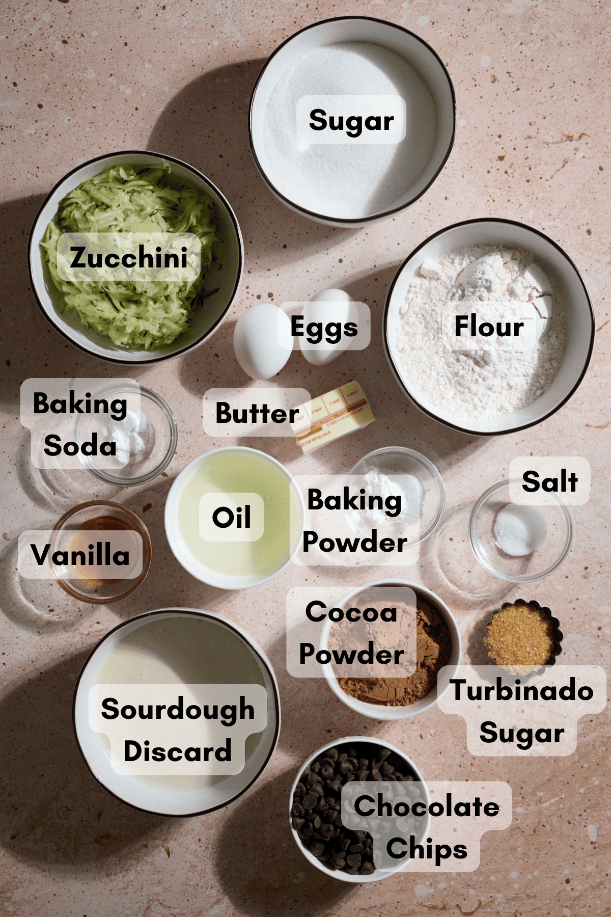 Ingredients for Chocolate Sourdough Zucchini Muffins in small bowls.