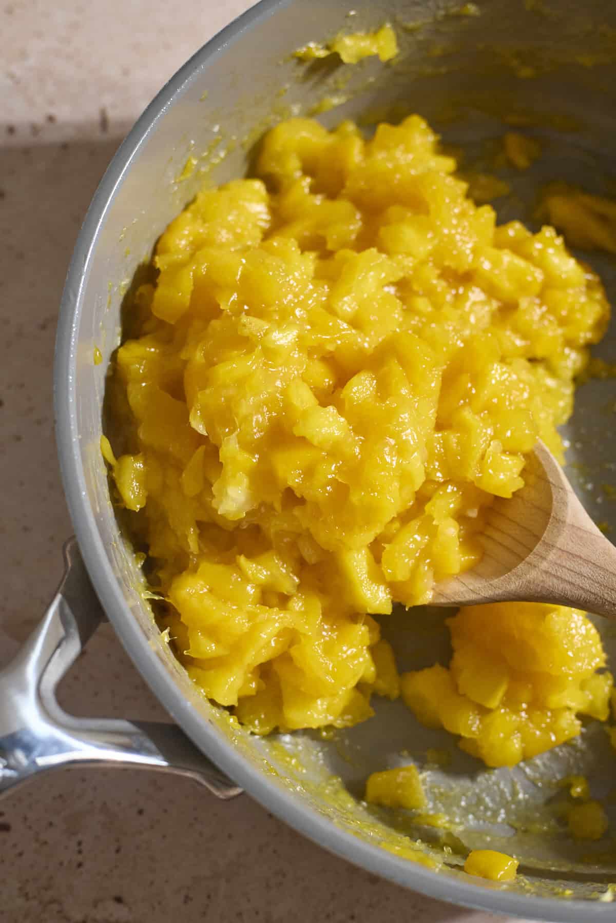 Jammy mango mixture in a saucepan.